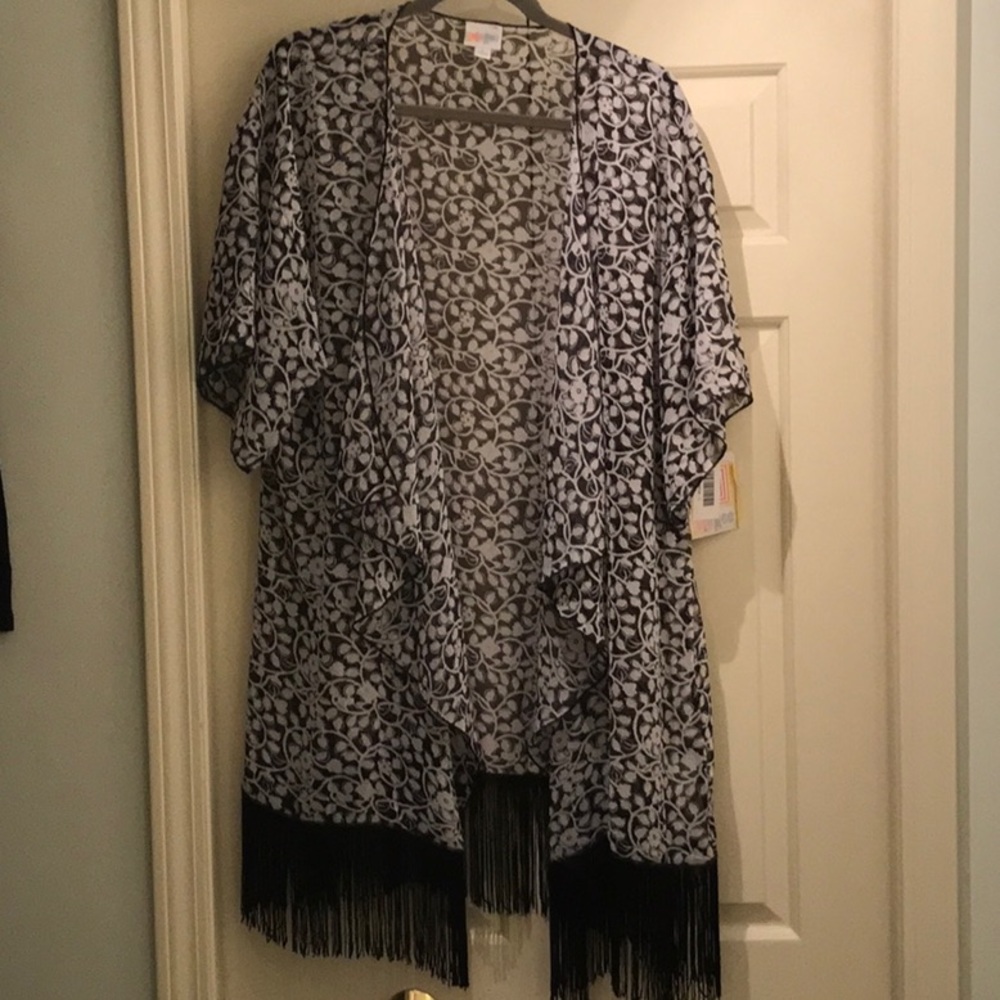Black and white patterned coverup w black fringe.